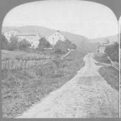 SA0277 - General view of a road and buildings. Identified on the back.